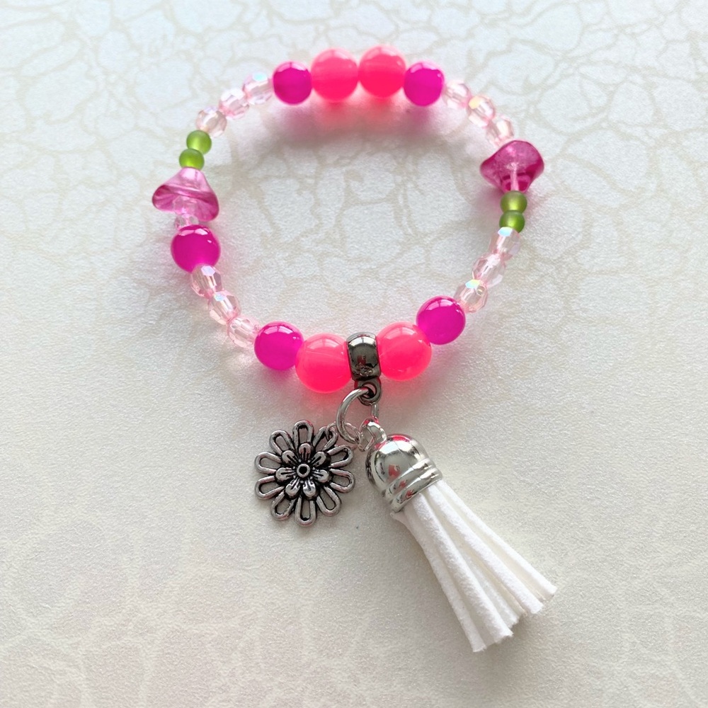 Pink Beaded Bracelet with a flower charm and tassel charm